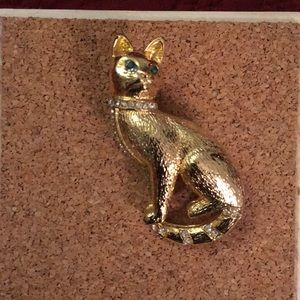 Gold cat with white and green rhinestone eyes, used